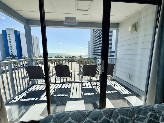 balcony featuring visible vents and a city view