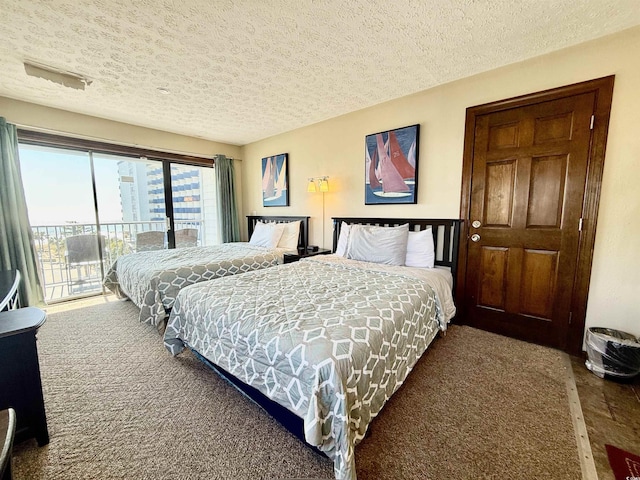 carpeted bedroom featuring access to outside and a textured ceiling