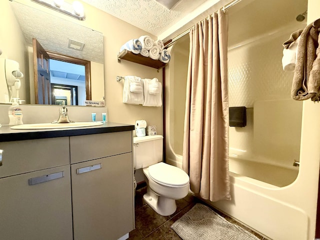 bathroom featuring shower / tub combo, toilet, tile patterned floors, a textured ceiling, and vanity