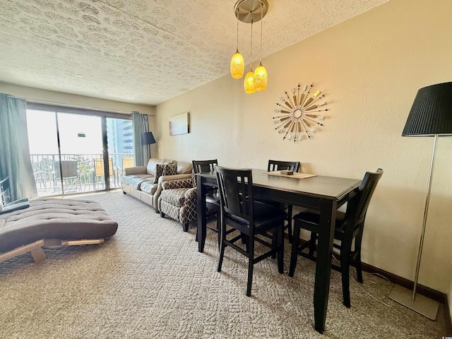 dining room featuring carpet floors, baseboards, a textured ceiling, and a textured wall