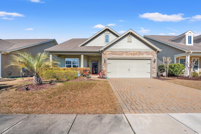 craftsman-style house featuring a garage and decorative driveway