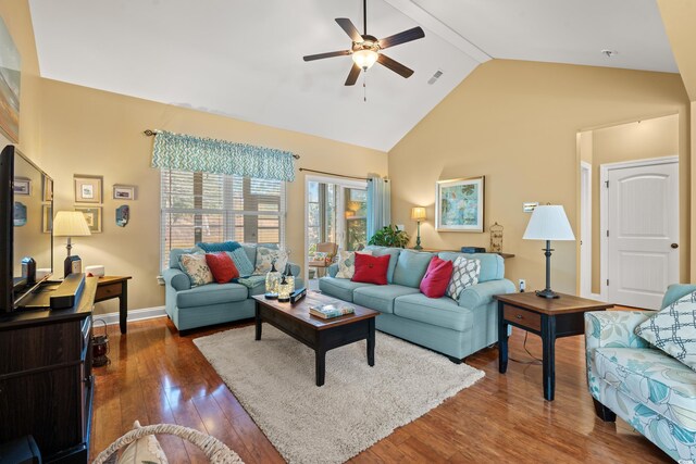 living room with visible vents, baseboards, ceiling fan, dark wood-style flooring, and high vaulted ceiling