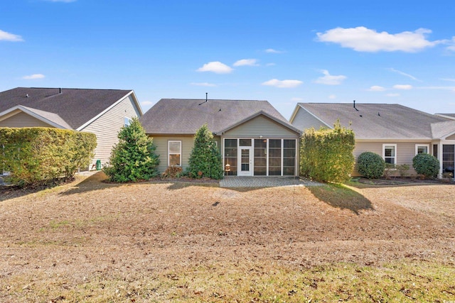 rear view of property featuring a sunroom