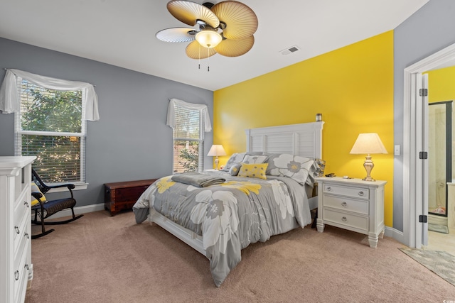 bedroom with visible vents, light carpet, baseboards, and multiple windows