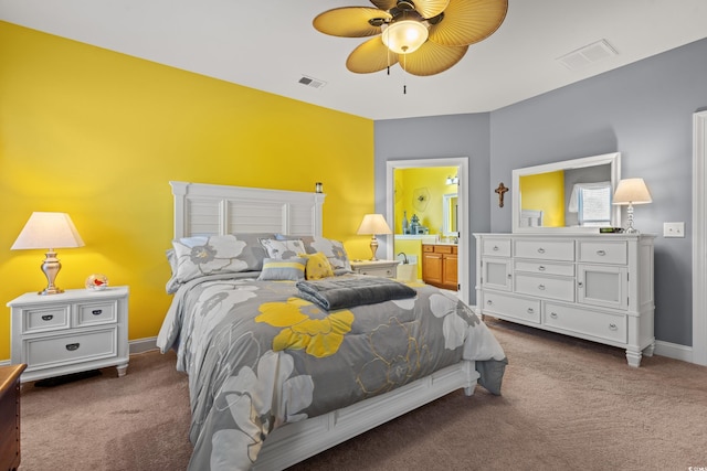 bedroom featuring baseboards, visible vents, carpet flooring, and ensuite bathroom