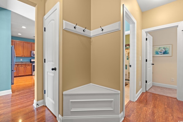 interior space featuring light wood-type flooring, baseboards, and recessed lighting