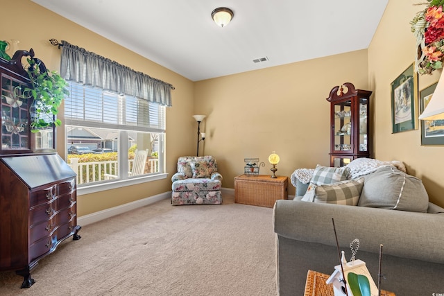 carpeted living area with visible vents and baseboards