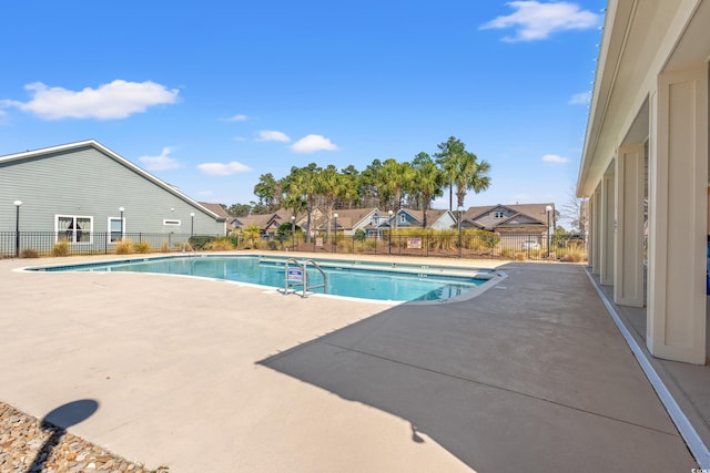 community pool featuring a patio area and fence