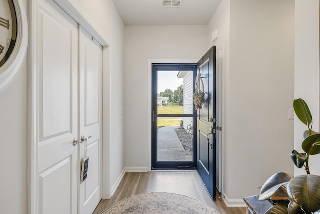 entrance foyer with light wood-style floors, baseboards, and visible vents