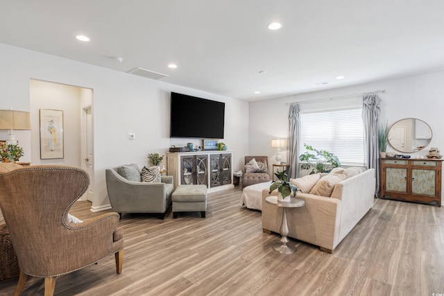 living area featuring light wood-style flooring, visible vents, and recessed lighting