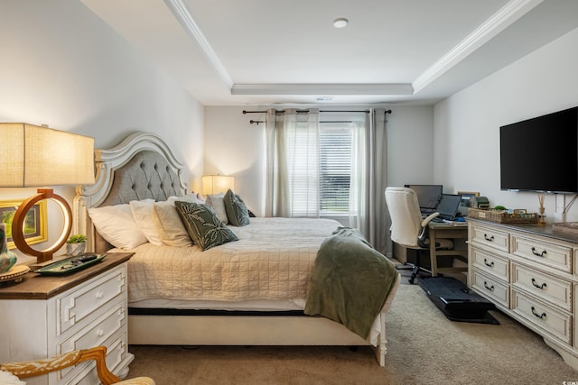 bedroom with ornamental molding, carpet floors, and a tray ceiling