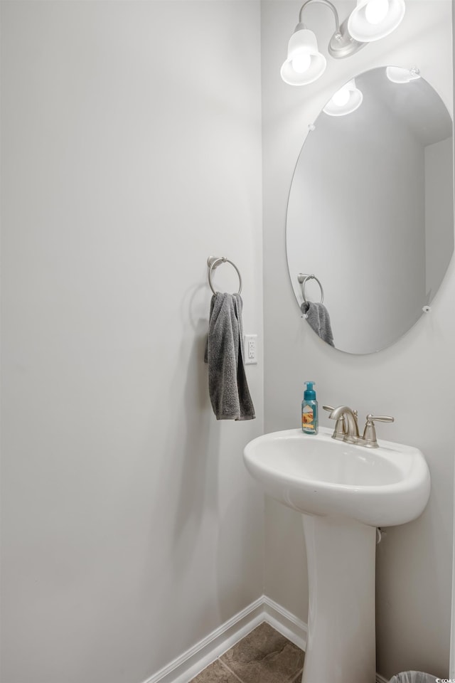 bathroom with baseboards and tile patterned floors