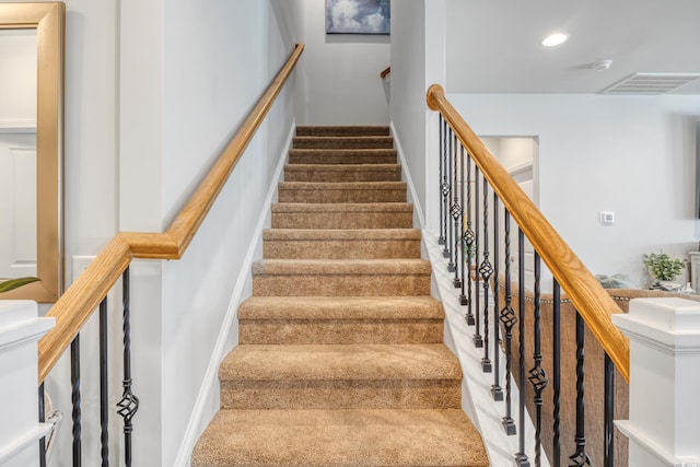 stairway with visible vents and recessed lighting