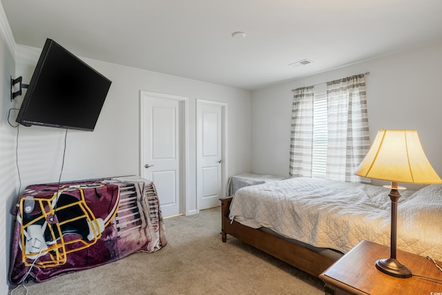 bedroom featuring carpet floors and visible vents