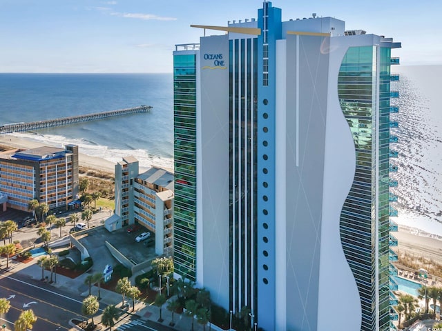 birds eye view of property featuring a water view and a beach view