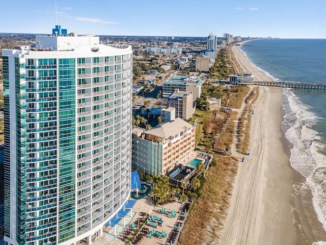 bird's eye view with a city view, a water view, and a beach view