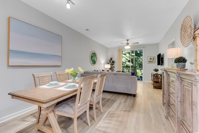 dining room featuring visible vents, baseboards, light wood finished floors, and ceiling fan