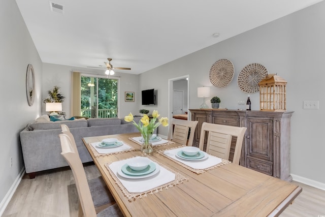 dining area featuring visible vents, baseboards, ceiling fan, and light wood finished floors