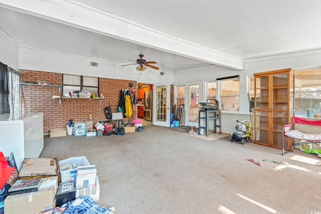 interior space with a ceiling fan, freestanding refrigerator, and visible vents