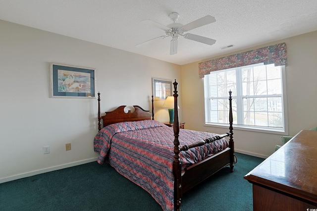 bedroom featuring visible vents, a ceiling fan, a textured ceiling, dark colored carpet, and baseboards