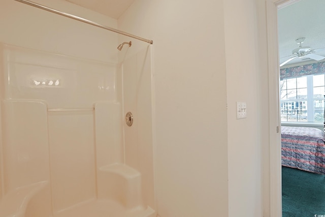 bathroom with a shower and a ceiling fan