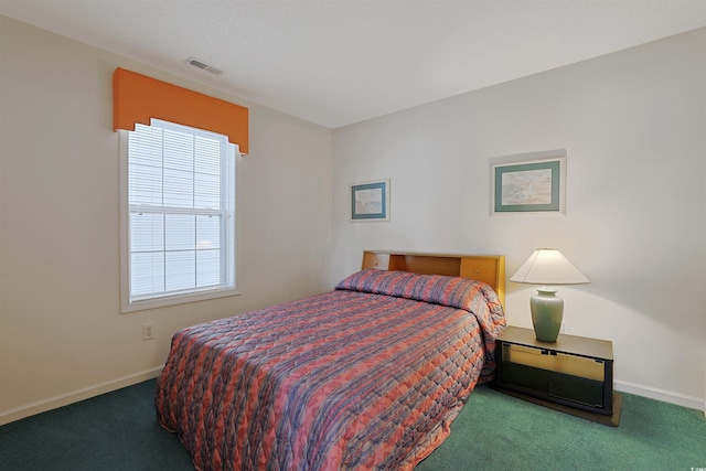 bedroom featuring visible vents, baseboards, and carpet