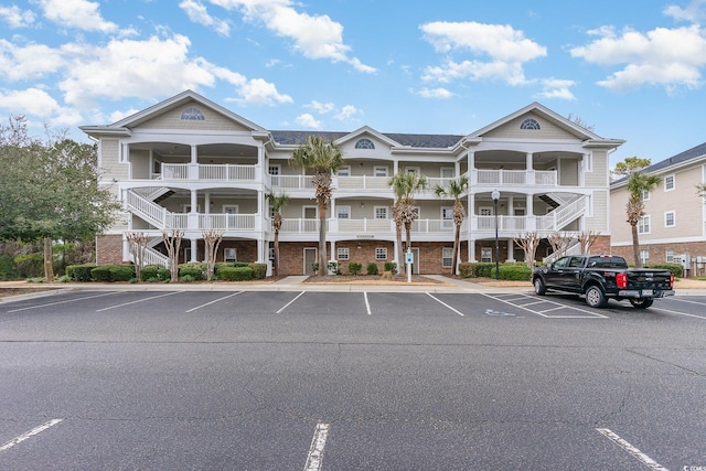 5801 Oyster Catcher Dr Unit 724, North Myrtle Beach, SC 29582 - view of building exterior with stairs and uncovered parking