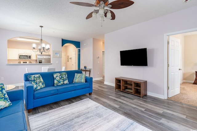 5801 Oyster Catcher Dr Unit 724, North Myrtle Beach, SC 29582 - living room featuring arched walkways, a ceiling fan, wood finished floors, a chandelier, and a textured ceiling