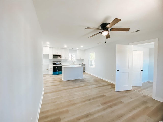 kitchen with ceiling fan, white cabinets, baseboards, appliances with stainless steel finishes, and visible vents