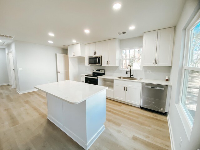 kitchen with plenty of natural light, visible vents, appliances with stainless steel finishes, and a sink
