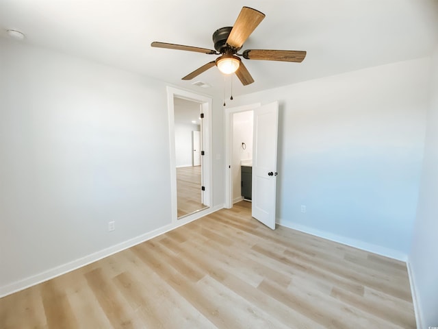 unfurnished bedroom with light wood-type flooring, visible vents, baseboards, and ceiling fan