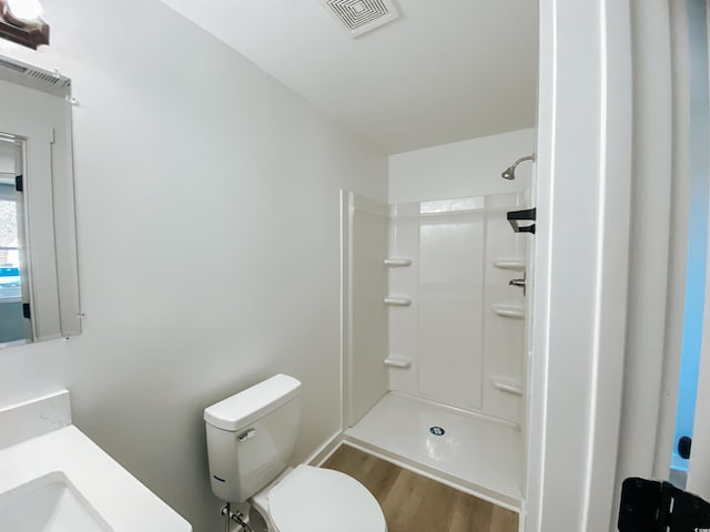 full bathroom with wood finished floors, visible vents, a shower, and toilet