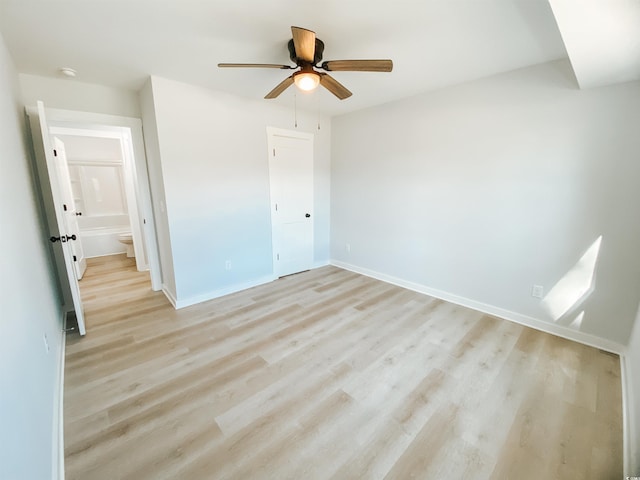 unfurnished bedroom featuring baseboards, a ceiling fan, and light wood-style floors