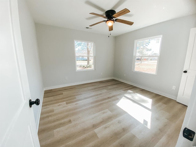 unfurnished bedroom featuring baseboards, visible vents, light wood-style floors, and ceiling fan
