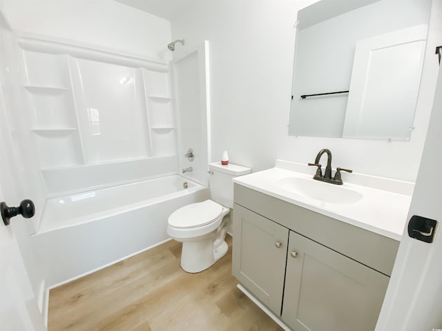 full bath featuring shower / bathing tub combination, wood finished floors, vanity, and toilet