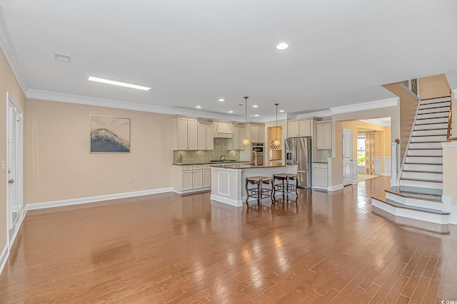 kitchen with tasteful backsplash, cream cabinets, dark countertops, and stainless steel fridge with ice dispenser