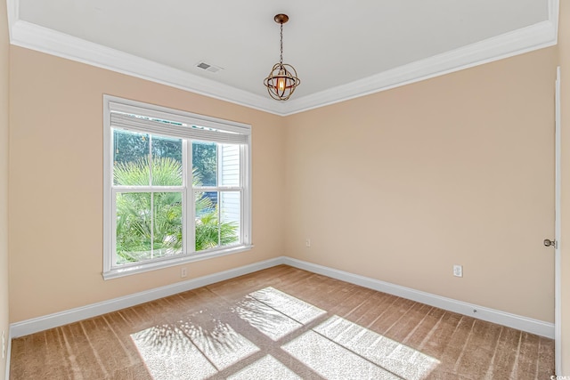 spare room featuring light colored carpet, ornamental molding, baseboards, and a chandelier
