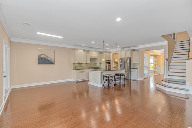 kitchen featuring stainless steel fridge, custom exhaust hood, dark countertops, a breakfast bar, and baseboards