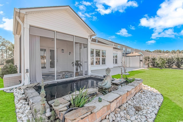 rear view of property with a sunroom, french doors, and a patio