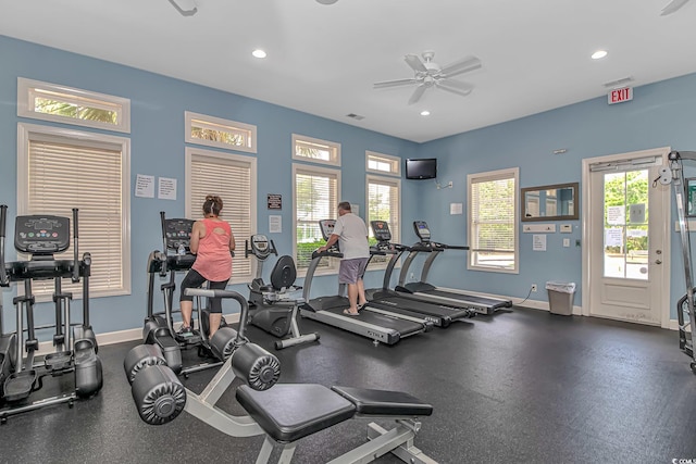 gym with baseboards, recessed lighting, visible vents, and a healthy amount of sunlight