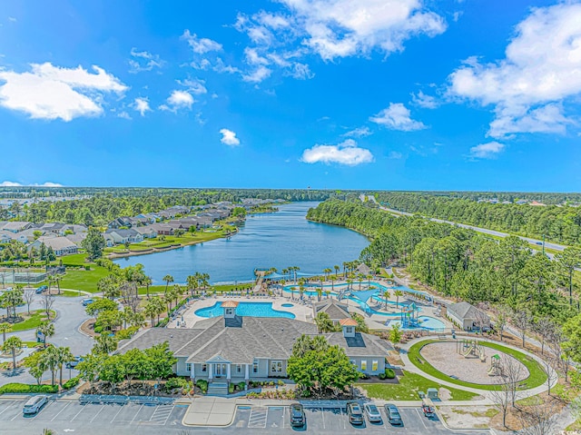 drone / aerial view of a large body of water and a pool
