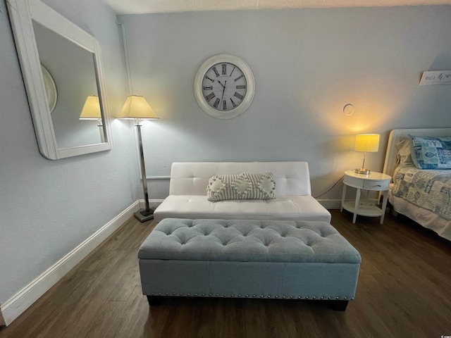 bedroom with baseboards and wood finished floors