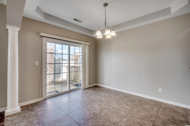 tiled spare room featuring baseboards, visible vents, ornate columns, and a textured ceiling