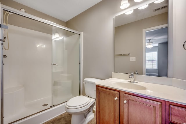 bathroom with vanity, toilet, visible vents, and a stall shower