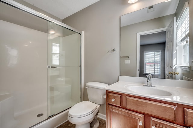 bathroom featuring visible vents, a shower stall, toilet, and vanity