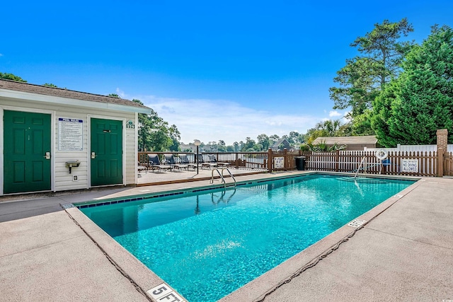 pool featuring a patio area and fence