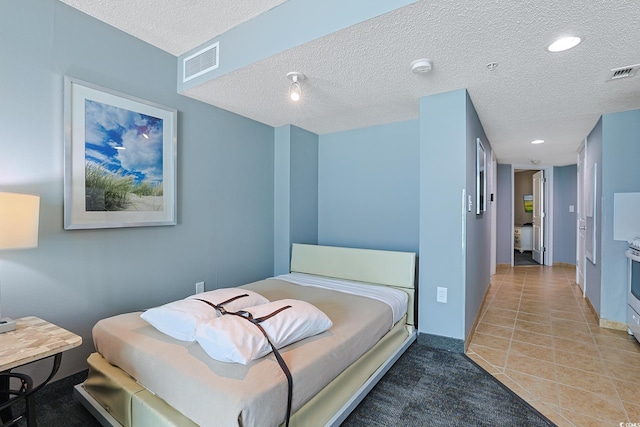 bedroom with recessed lighting, visible vents, and a textured ceiling