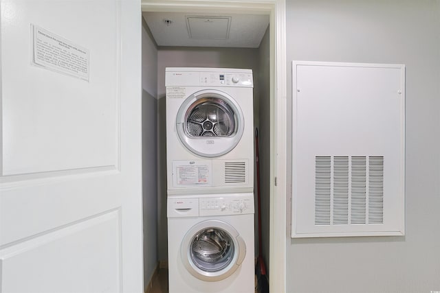 washroom featuring stacked washer / dryer