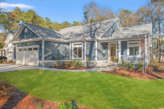 view of front facade with covered porch, concrete driveway, an attached garage, and a front yard