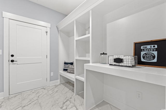 spacious closet featuring marble finish floor